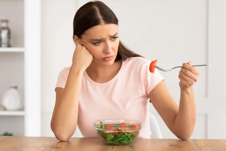 Sad Woman Eating Salad