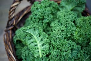 kale-in-rustic-basket-on-daylight-close-up