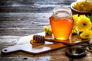 honey-jar-with-honey-dipper-shot-on-rustic-wooden-table