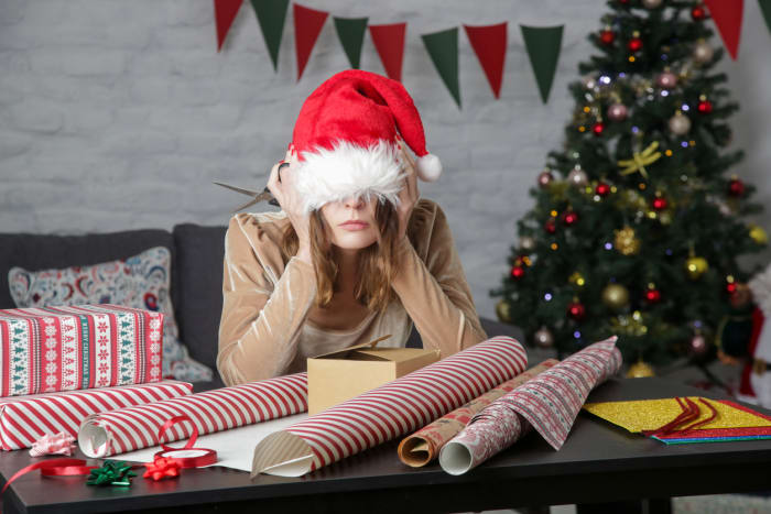 depressed-frustrated-woman-wrapping-christmas-gift-boxes-winter-holiday-stress-concept